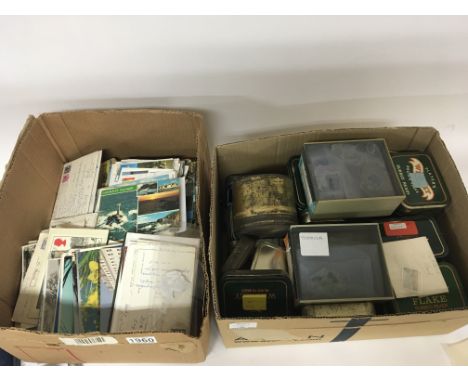 A box containing post cards and a box containing vintage tobacco tins containing world stamps (a lot)
