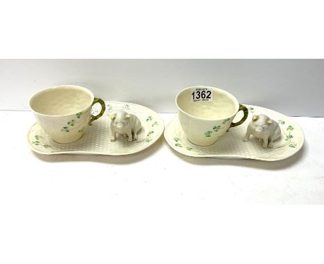 2 Belleek porcelain cups and saucers together with to Belleek porcelain pig figures. (D).