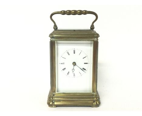 A brass strike repeating carriage clock, with key. Approximately 9x8x16cm. (B)