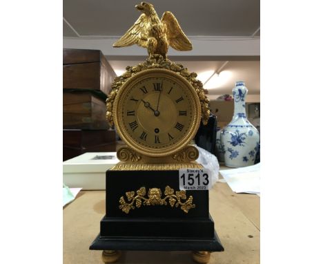 A Victorian mantle clock, made in London- the dial having Roman numerals, surmounted by a brass eagle and wreath of acorns an