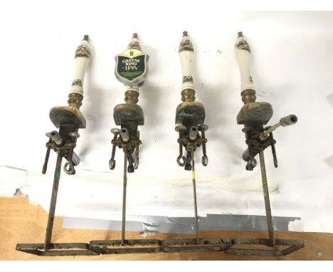 Four beer vintage porcelain and brass pump handles