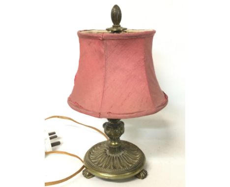 An electric brass lion claw feet table lamp, approximately 30cm tall