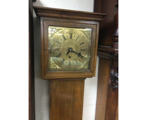 A walnut longcase clock with a brass dial, approx height 178cm. Shipping category D.