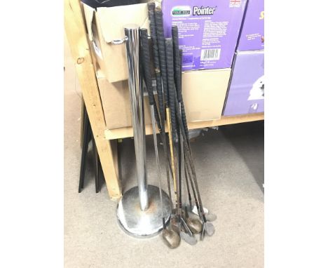 A collection of vintage left handed golf clubs