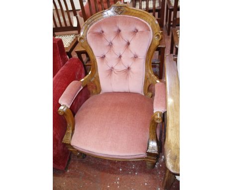 A Victorian walnut button back upholstered armchair.