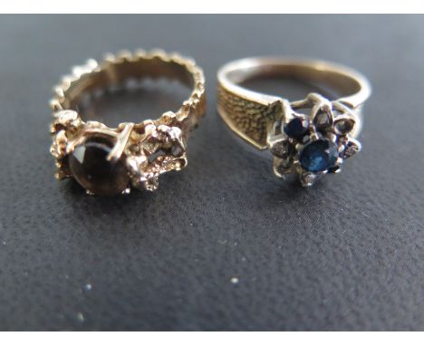 A 9ct yellow gold ring set with smoked quartz to shoulder and a 9ct yellow gold ring set with sapphires and diamonds - some s