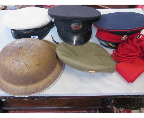 A tin helmet, sash, two Merchant Navy peaked caps, household Cavalry peaked cap and Spanish beret 