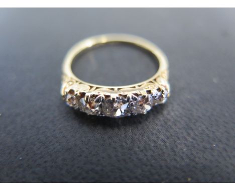 An 18ct yellow gold five stone diamond ring size P - approx weight 3.3 grams - total diamond weight approx 1.3ct - light surf