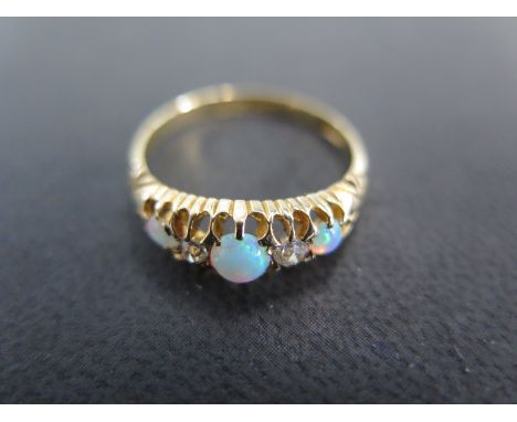 An 18ct yellow gold opal and diamond ring size Q/R - approx weight 3.2 grams - some very light scratches and mild usage wear 