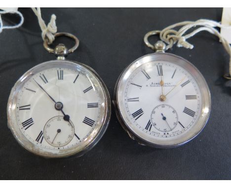 An open faced silver cased pocket watch with Roman numerals to white enamel dial with subsidiary seconds at 6 o'clock - runni