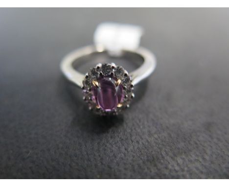 An 18ct white gold cabochon purple sapphire and diamond cluster ring - approx weight 1.08ct - ring size M - approx weight 5 g