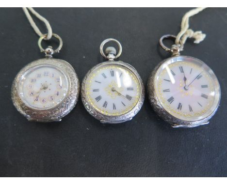 Three ladies silver engraved cased open faced pocket watches, two having Roman numerals to white enamel dials, one with Arabi