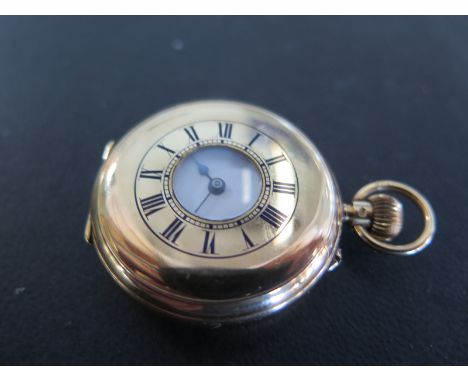 An 18ct yellow gold cased half Hunter ladies pocket watch with white enamel dial with Roman numerals, assayed to back 18 Lond