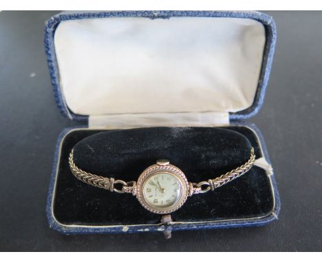 A 9ct yellow gold cased ladies Jaeger Le Coultre wristwatch, Arabic numerals at 12, 2,4, 6, 8 & 10 on a 9ct yellow gold brace