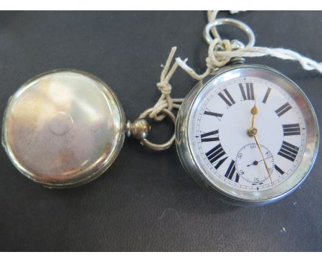 A full Hunter silver cased pocket watch by Baume of Geneve, Roman numerals to white enamel dial with subsidiary seconds at 6 