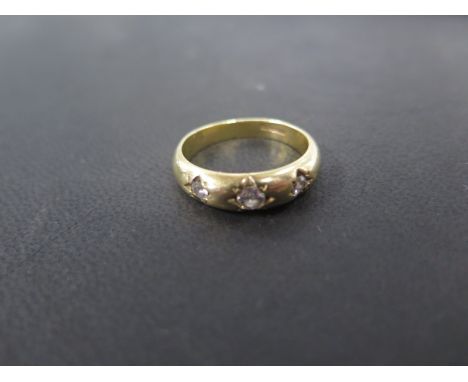 An 18ct yellow gold three stone diamond ring size U - approx weight 8 grams - central diamond approx 0.25ct - diamonds bright