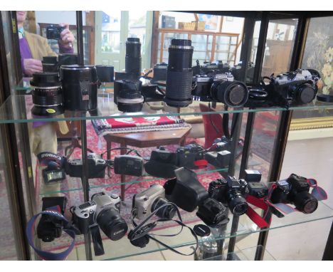 A large quantity of SLR cameras to include Canon EOS 1000F+ 500N Olympus OM10 with manual adapter Canon AV1, Miranda M, Fujic