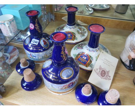 Four Wades Ceramic decanters containing Pussers Navy Rum all wax sealed with cork stoppers - two are ships decanters - all go