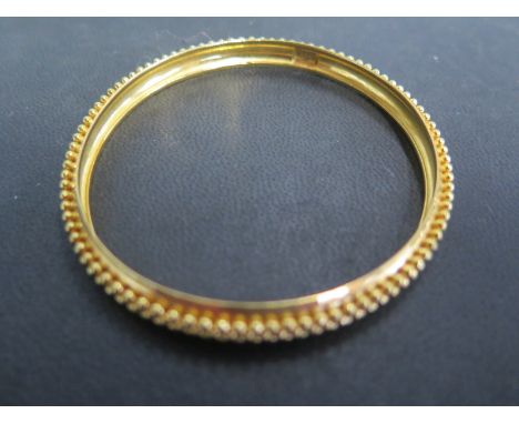 A 22ct yellow gold bangle - approx weight 18 grams - ribbed design to outer edge - in good clean and bright condition 