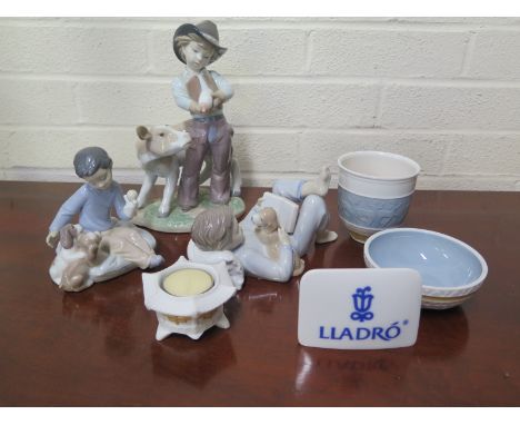 A group of Lladro figures and items including 8607 Cowboy with Calf, 6985 Boy with Puppet and Puppies, 8034 Boy Reading with 