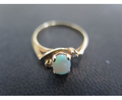 A 14ct gold opal and diamond ring size P - approx weight 2.1 grams - very light scratches, usage wear 