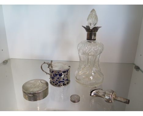 A Georgian silver mustard, a Georgian silver patch pot, maker SP, a silver top decanter 21cm tall, a silver powder pot and a 