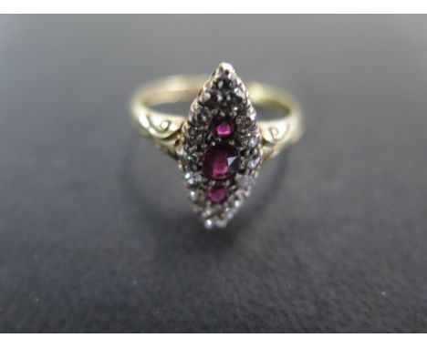 An 18ct yellow gold diamond and ruby navette shaped ring size N/O - approx weight 3.2 grams - some light scratches, usage wea