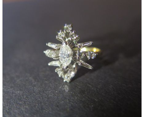 A good 18ct yellow gold diamond cluster ring the central marquise cut diamond approx 0.44ct surrounded by circular and baguet