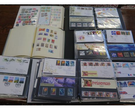 An extensive collection of First Day Covers from 1966 to 2000 in five albums and two albums containing World stamps 
