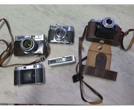 A selection of rangefinder cameras by Voigtlander, Kodak and Minolta with an Agfa bellows camera and a Rollei 165 