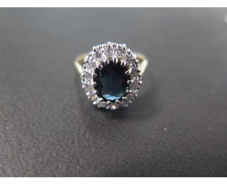 An 18ct yellow gold Burmese sapphire and diamond ring - The central sapphire approx 7.5mm x 9mm x 3.5mm surrounded by 14 diam