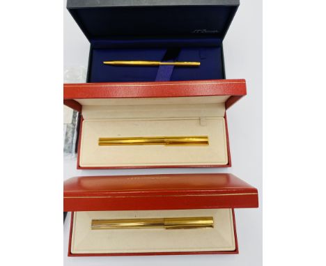 A Dupont gold plated ballpoint pen in original box; a gold plated Dupont ballpoint pen in box; a Dupont pen as found; togethe