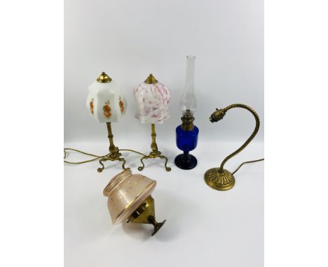 A collection of lamps to include,a pair of brass pullman lamps with faceted columns and tripod legs with glass shades,a Brist