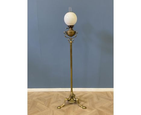 A decorative early 20th century brass telescopic oil lamp, with a glass chimney and milk glass shade, 49 x 49 x 165cms and ex