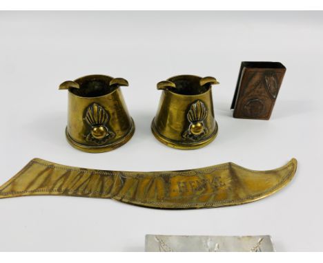 Two trench art ashtrays; together with a brass trench art paper knife and other associated items. Estimate £25-40.