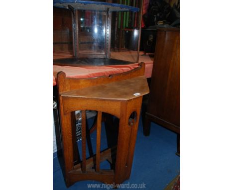 An unusual Oak Arts and Crafts Corner Stick Stand having a fretworked central slab support, 26" wide x 32 1/4" high x 9 3/8" 