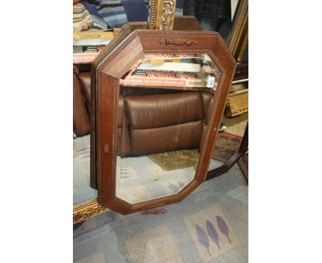 An octagonal bevel edged wall Mirror in light oak frame with raised detail, 32'' x 21''.