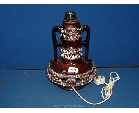 A German pottery two handled  Lamp in brown with holes to the base to let the light shone through, crack to the body, 13'' ta