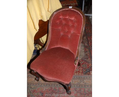 A Victorian Mahogany framed button back Chair upholstered in dusty pink Dralon and standing on scroll front legs.
