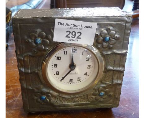 Arts and Crafts beaten pewter mantle clock case having later movement marked 'Mercedes'