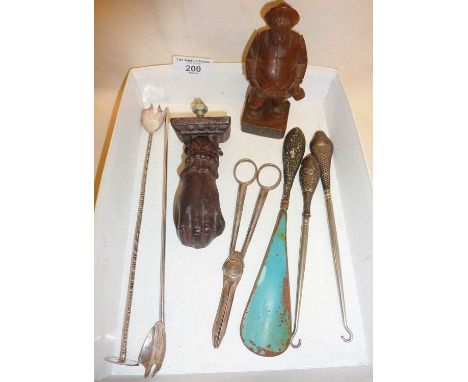 Anri carving of man, silver handled button hooks and shoe horn, cocktail stirrers, grape scissors and a door knocker in the s