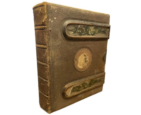 A large leatherbound Victorian photograph album with ceramic floral panels to upper boards. Containing over 13 portrait photo