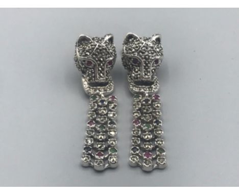 A pair of silver and marcasite designer style leopard head earrings with ruby eyes 13.10g gross