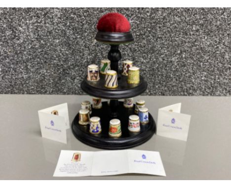 Royal Crown Derby historical thimble collection, includes 15 (different pattern thimbles on stand with pin cushion)