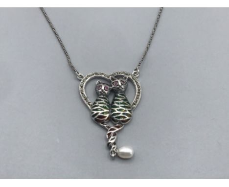 A silver marcasite and enamel heart shaped pendant necklace in the form of cats 9.43g gross