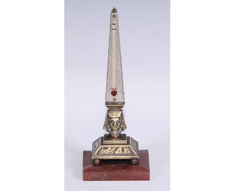 An Egyptian Revival desk thermometer, cast as an obelisk and pharaoh's head, silvered register, square rosso antico marble ba