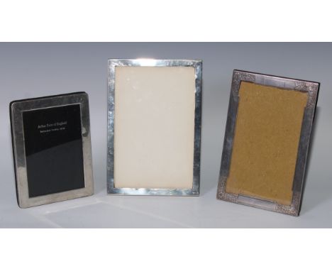 A George V silver rectangular easel photograph frame, engine turned border engraved to the angles with flowerheads and stiff 