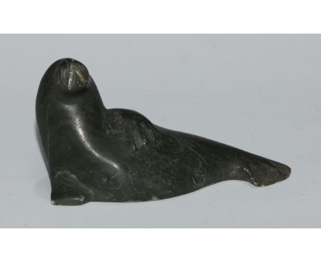An Inuit greenstone carving, of a seal, 11cm wide, inscribed BA**, 5N40519, ink manuscript label and Eskimo Art sticker, 11cm