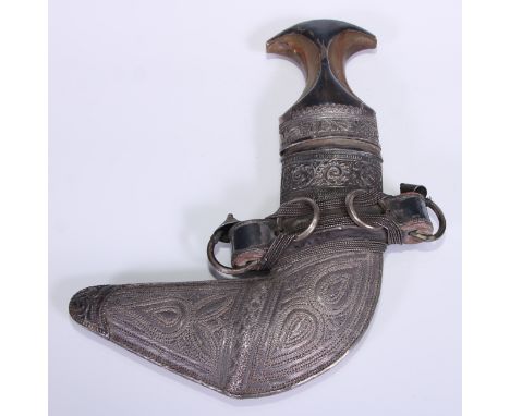 A Middle Eastern silver mounted jambiya dagger, 17cm curved blade with central ridge, horn grip, the scabbard chased with lea