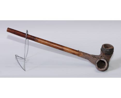 Tribal Art - a pipe, probably African, the terracotta double-bowl hide bound, wooden shaft incise-carved with a geometric ban